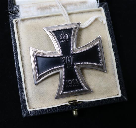 First Class iron cross in box and a German 2nd World War arm badge
